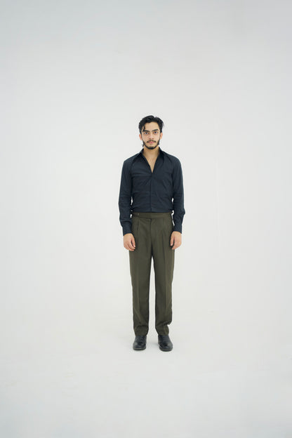 Man wearing a black shirt and green pants on a white background