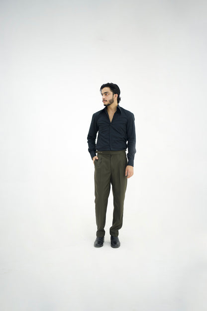 Man wearing a dark shirt and green pants on a white background